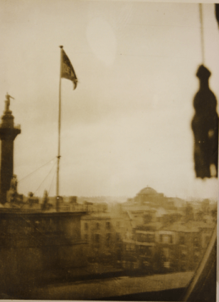 Photograph of the Irish Republic flag flying above the G.P.O., taken from a room in the Metropole Hotel (NMI Collection) Image