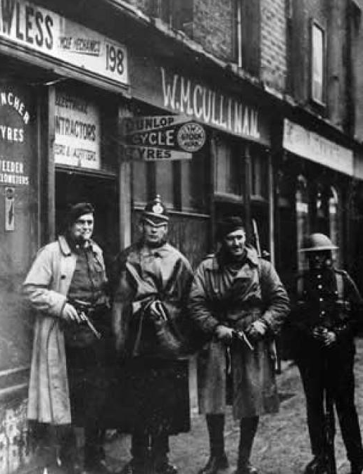 British soldiers, two Auxiliaries and a DMP constable at the Heron and Lawless premises at 198 Parnell Street after the raid. (http://www.standingwellback.com/home/2014/12/30/ira-improvised-munitions-1919-1922.html)
